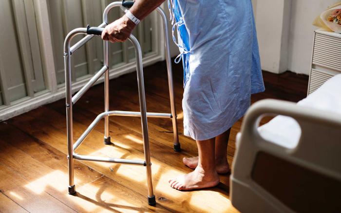 Patient walking with a walker.