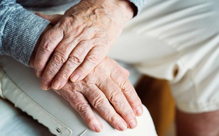 A pair of hands crossed on top of each other.