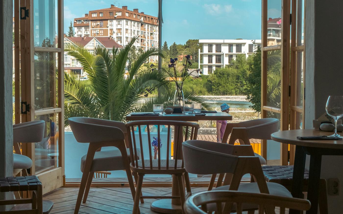 a patio with tables and chairs by Alex jiang courtesy of Unsplash.